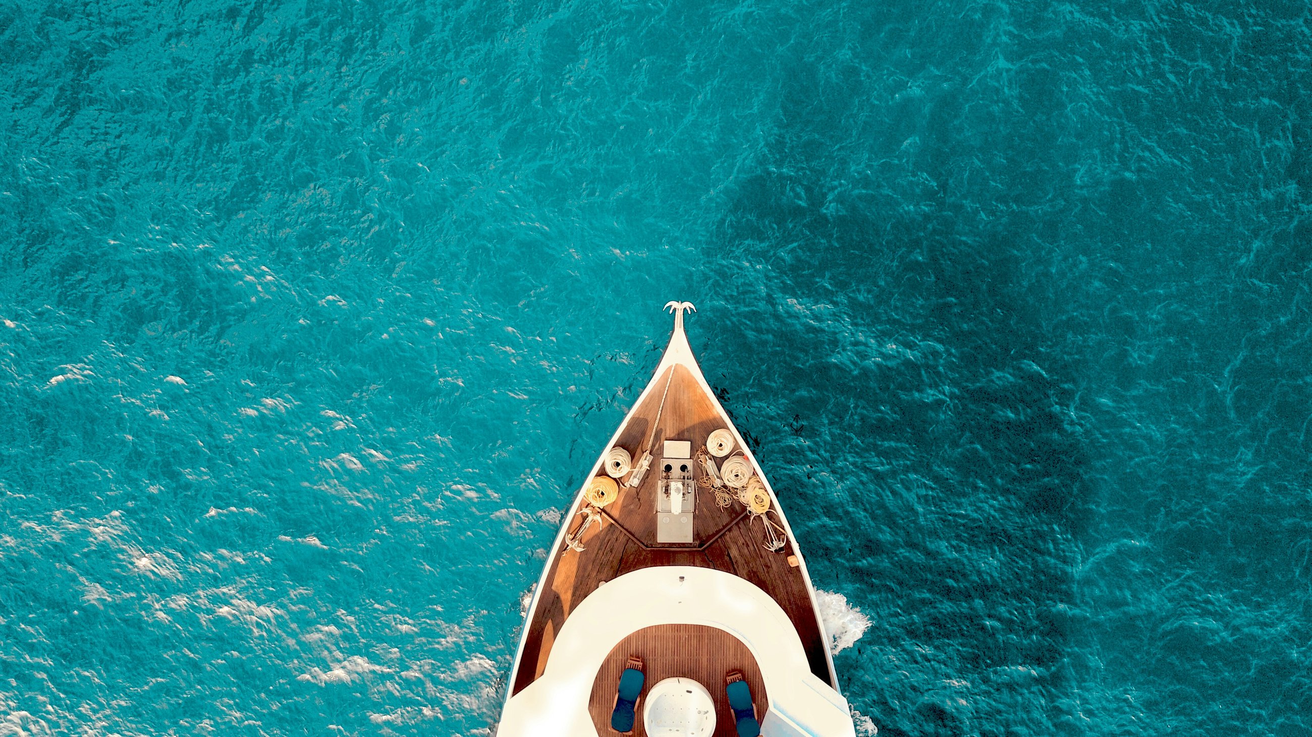 Aerial view of a yacht bow over turquoise water